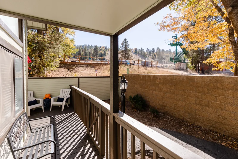 Outdoor deck with Adirondack seating and views toward the resort